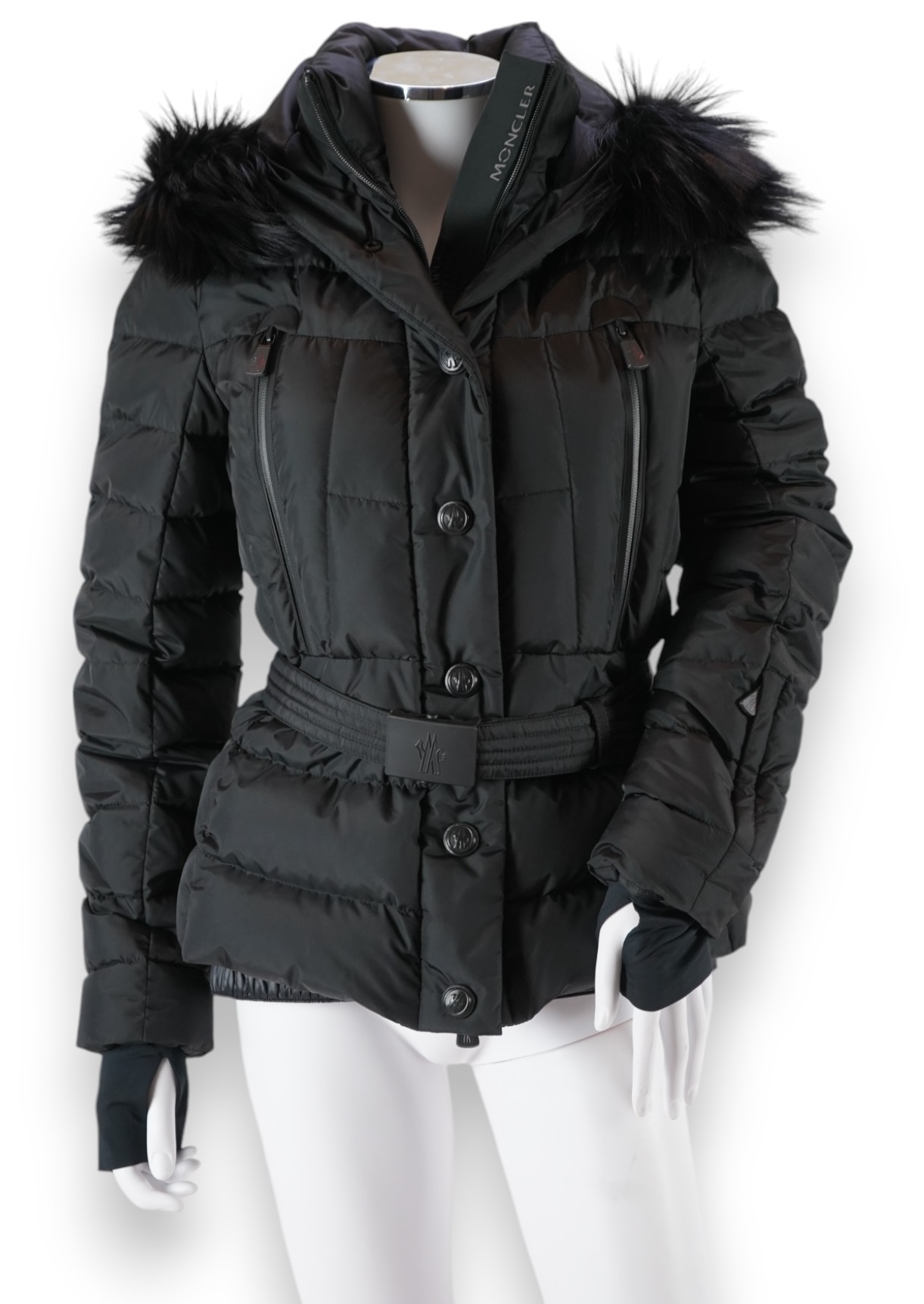 A lady's Moncler Grenoble down black ski jacket with fur trimmed hood and belted waist. UK size 10